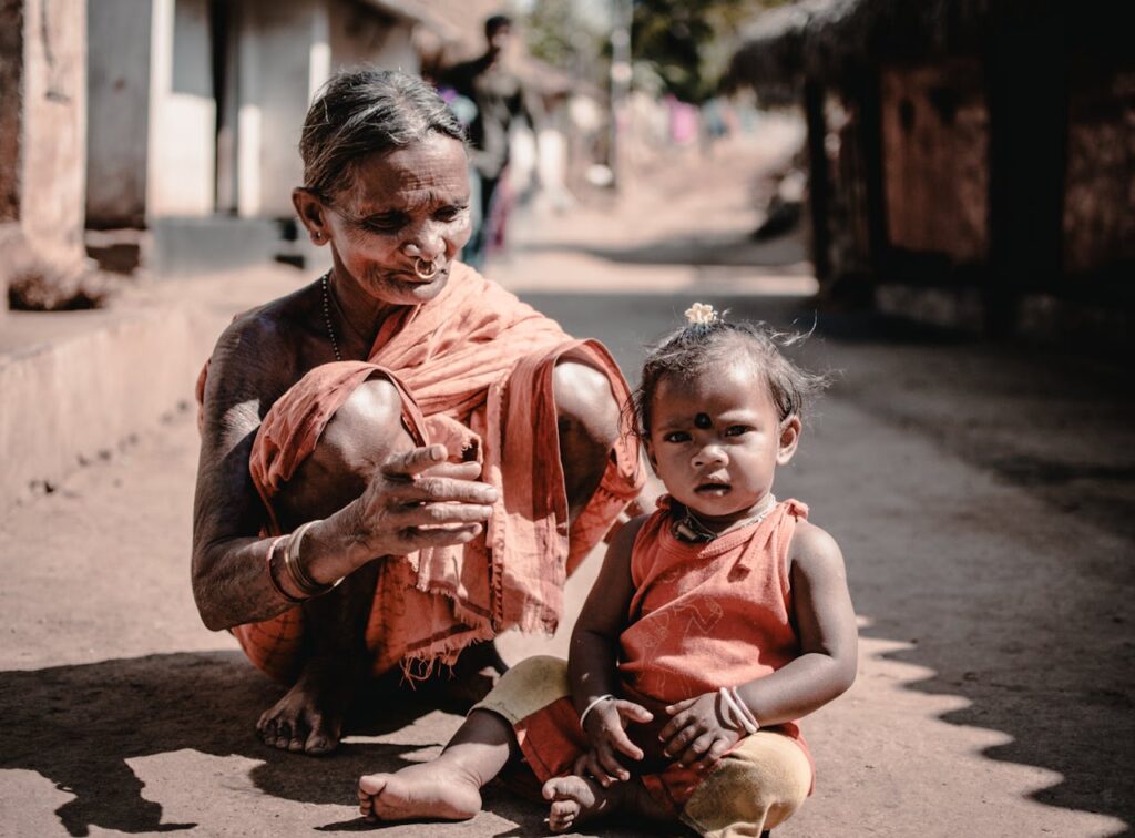 Charming scene of a grandmother and child in a traditional village setting in Odisha, India.